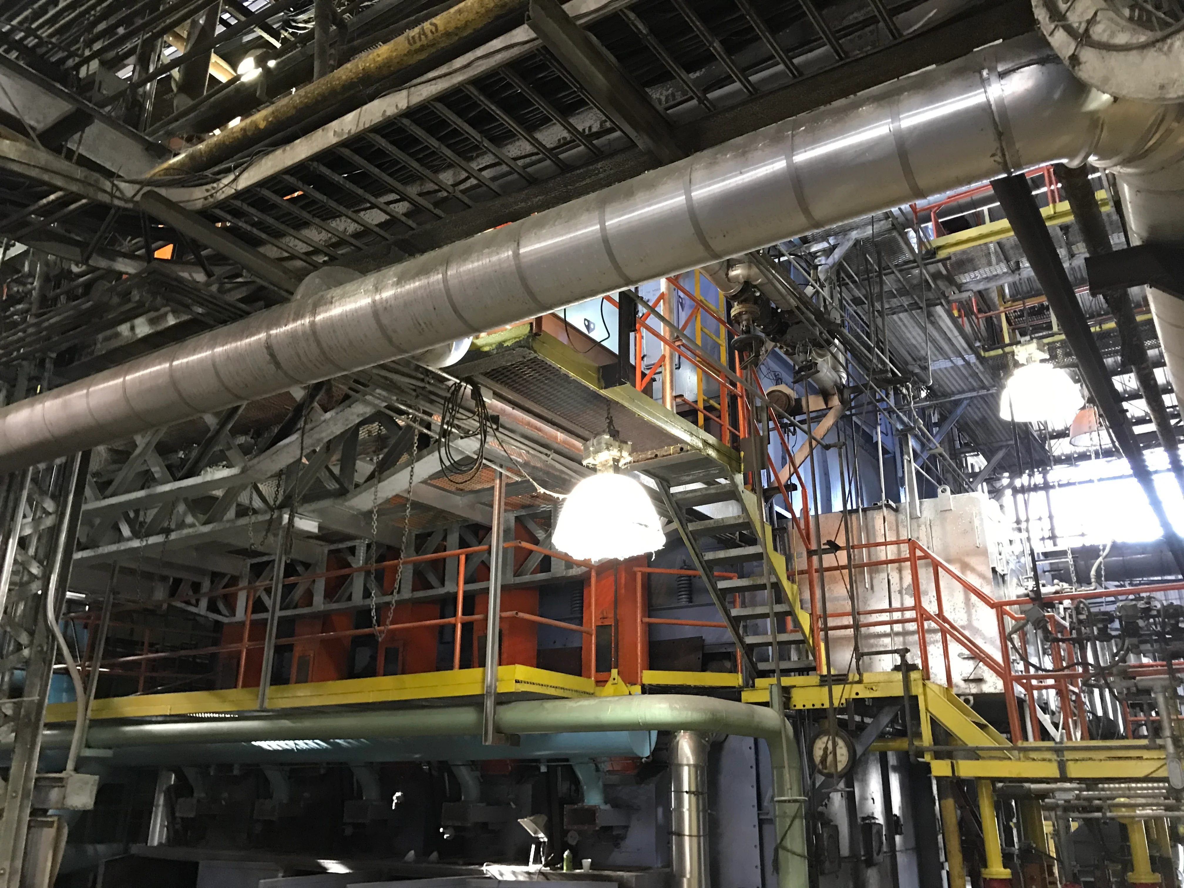 Close-up of boiler tubes, a cylindrical header, and supporting steelwork.
