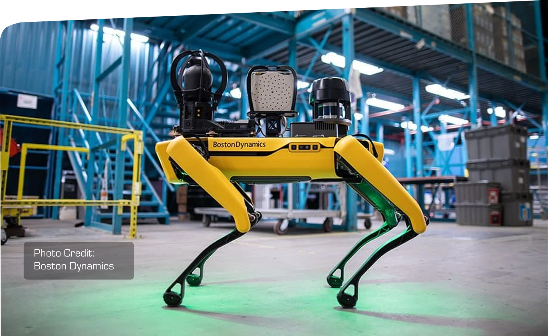Boston Dynamics Spot robot dog equipped with scanning payloads standing in an industrial warehouse. Photo credit: Boston Dynamics