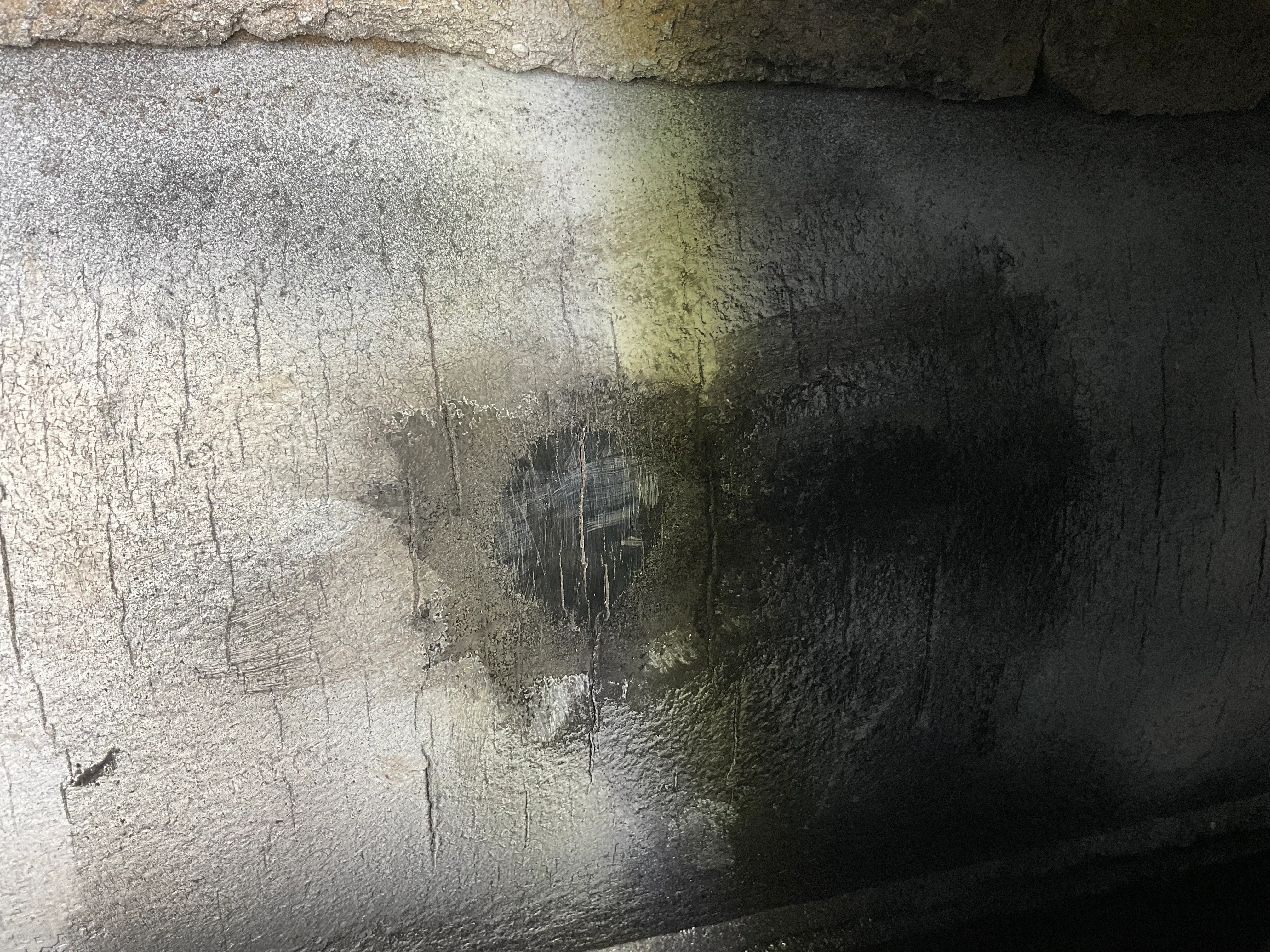 Close-up of heat-stress cracking on a furnace lower sidewall header